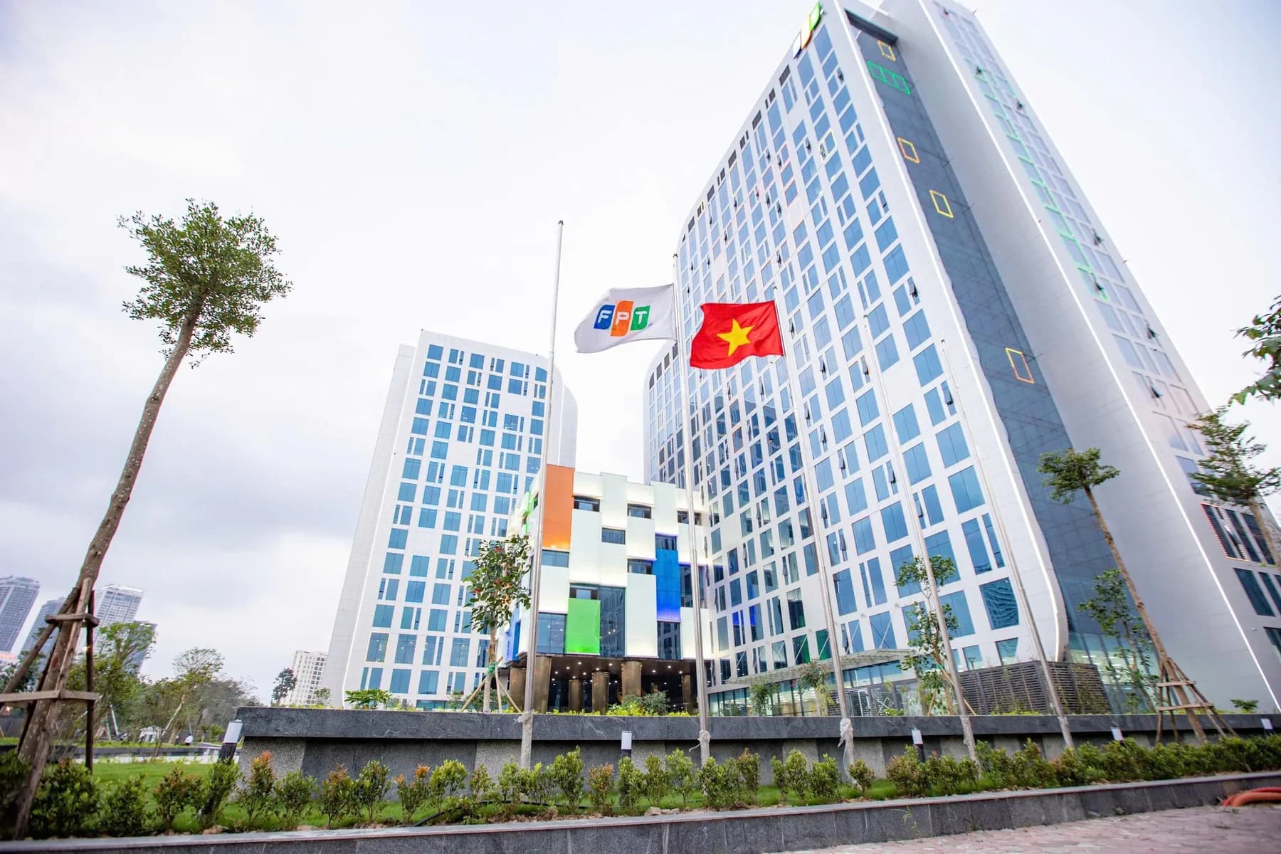 FPT office buildings, with the FPT flag and the Vietnamese flag flying outside
